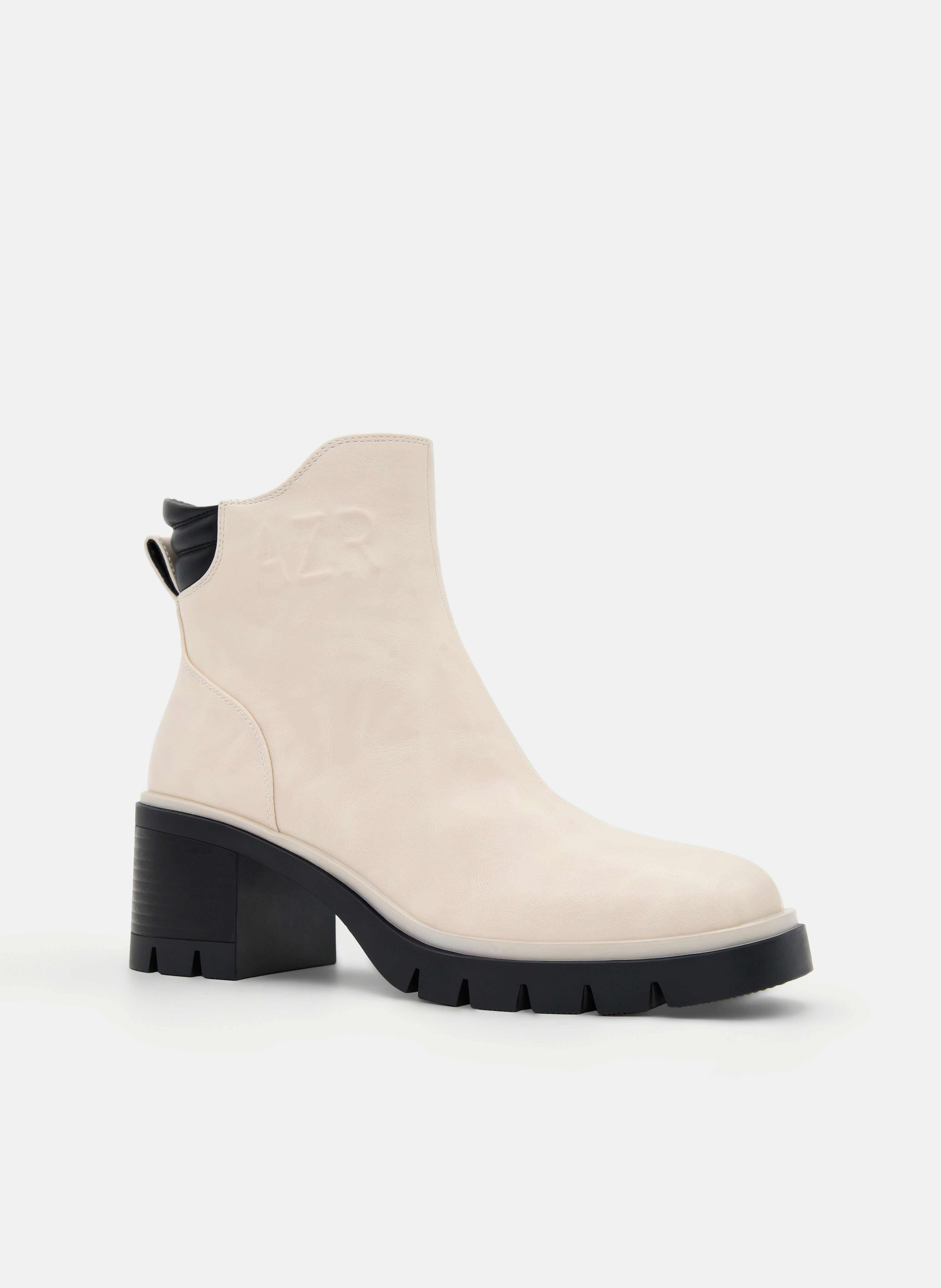 Beige ankle boots with a block heel and black detail.