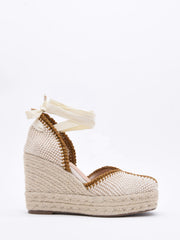 Wedge sandals in braided jute with ankle ties.
