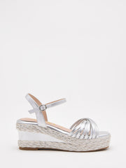 Silver wedge sandals with a woven platform and elegant straps