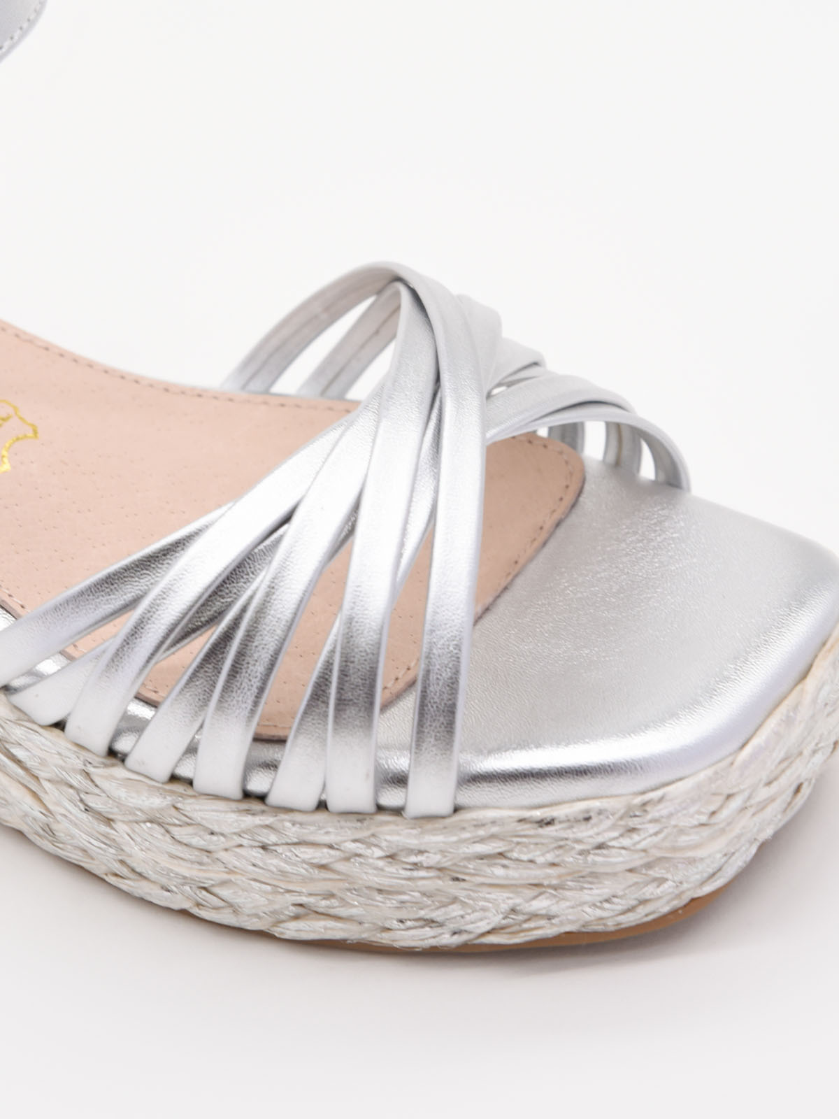 Silver wedge sandals with a woven platform and elegant straps